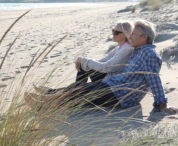 A couple in early retirement enjoying the beach|
