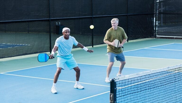 Two friends playing pickleball.|Pickleball coach and player Sara Johnson