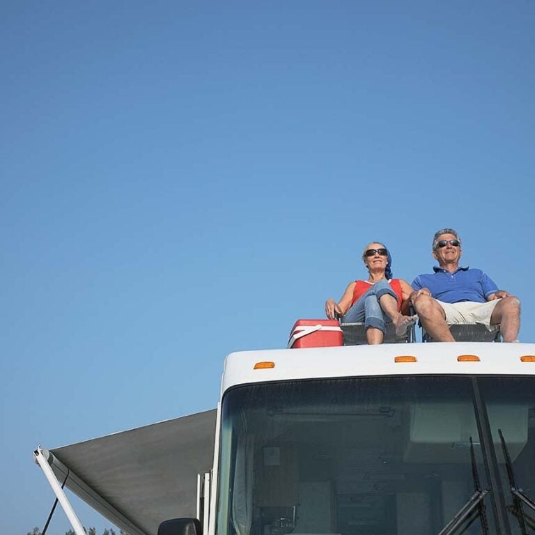 A couple on the roof of their RV