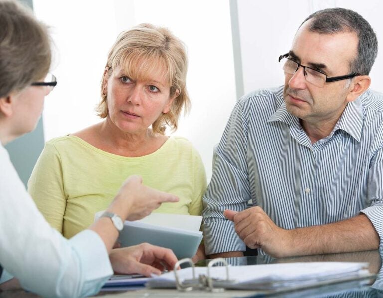 a couple discussing converting their traditional ira to a roth ira