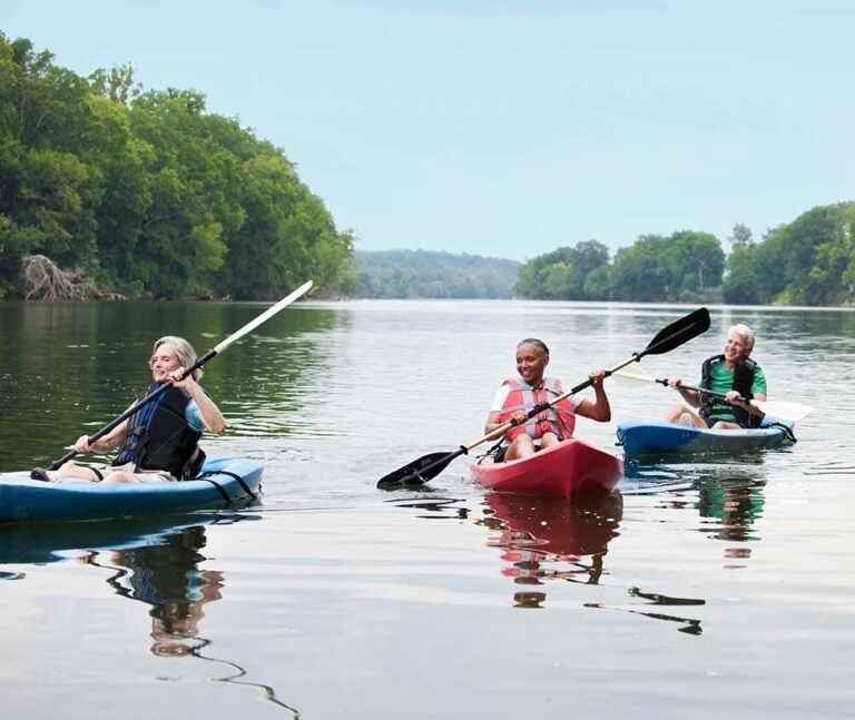 People finding fulfillment in kayaking in retirement|a hand holding ancestral photos|An older woman playing the guitar|A senior woman having a job interview|A senior woman learning to play guitar|family photos and writing about ancestry