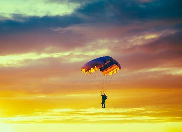 a skydiver at sunset|||