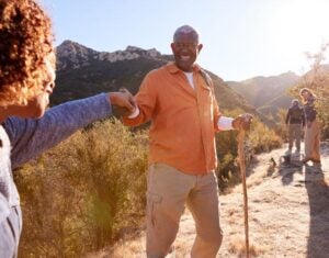 Folks on a hike enjoying a support system in retirement in real time
